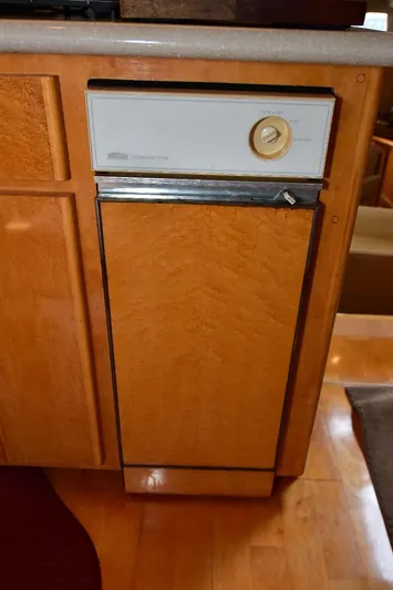 Next Chapter Yacht Photos Pics 2004 Navigator Rival dishwasher with wood paneling in a kitchen setting.