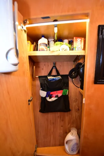 Next Chapter Yacht Photos Pics 2004 Navigator Rival RV cabinet with cleaning supplies and storage.