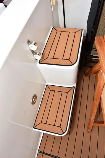 Next Chapter Yacht Photos Pics 2004 Navigator Rival boat steps with wood finish and non-slip surface.