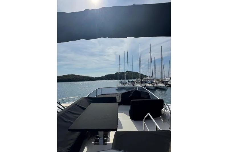  Yacht Photos Pics 2018 Cranchi E52 F yacht with scenic marina view and sailboats.