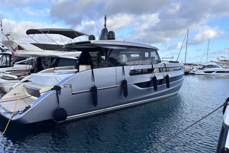  Yacht Photos Pics 2026 Invictus ST 550 yacht docked at marina under cloudy sky.