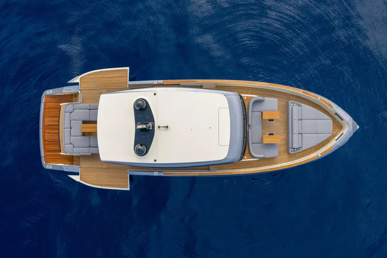  Yacht Photos Pics Aerial view of 2026 Invictus ST 550 luxury yacht on blue water.