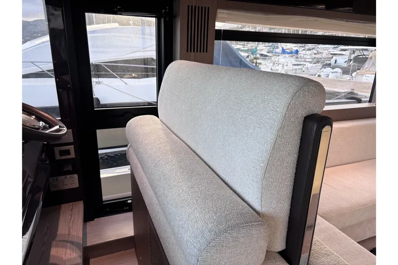  Yacht Photos Pics Interior of 2026 Invictus ST 550 yacht with plush seating and marina view.