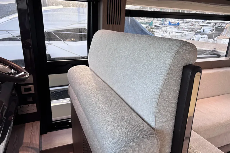  Yacht Photos Pics Interior of 2026 Invictus ST 550 yacht, featuring plush seating and marina view.