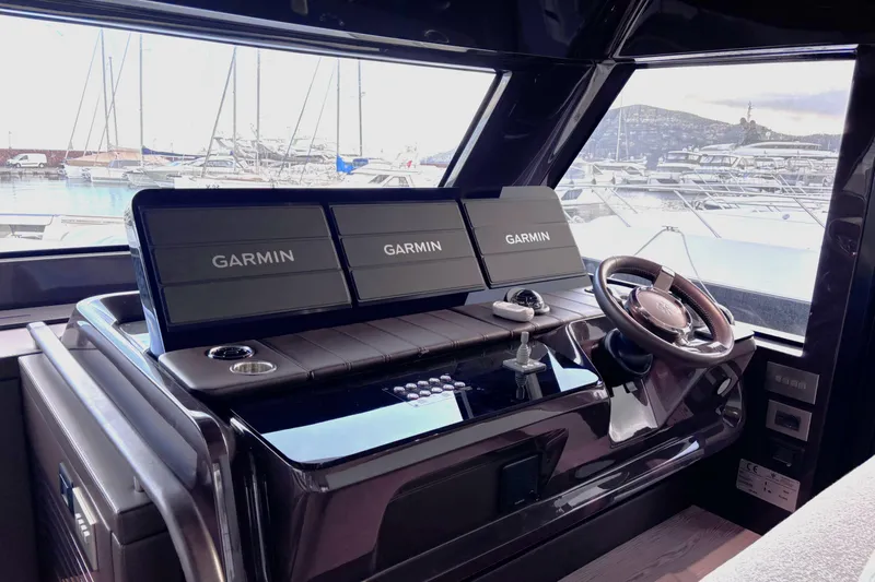  Yacht Photos Pics Helm of 2026 Invictus ST 550 yacht with Garmin navigation displays.