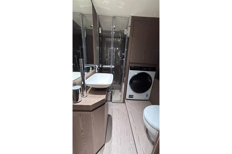  Yacht Photos Pics Luxurious bathroom in 2026 Invictus ST 550 yacht with modern fixtures and washer.