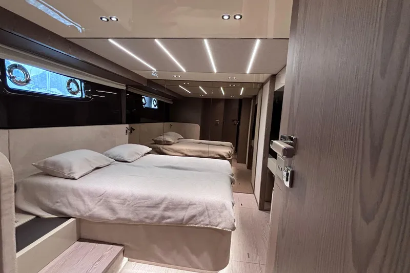  Yacht Photos Pics Luxurious interior of 2026 Invictus ST 550 yacht with modern twin beds and ambient lighting.