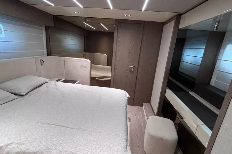  Yacht Photos Pics Luxurious bedroom interior of 2026 Invictus ST 550 yacht, featuring modern design and elegant furnishings.