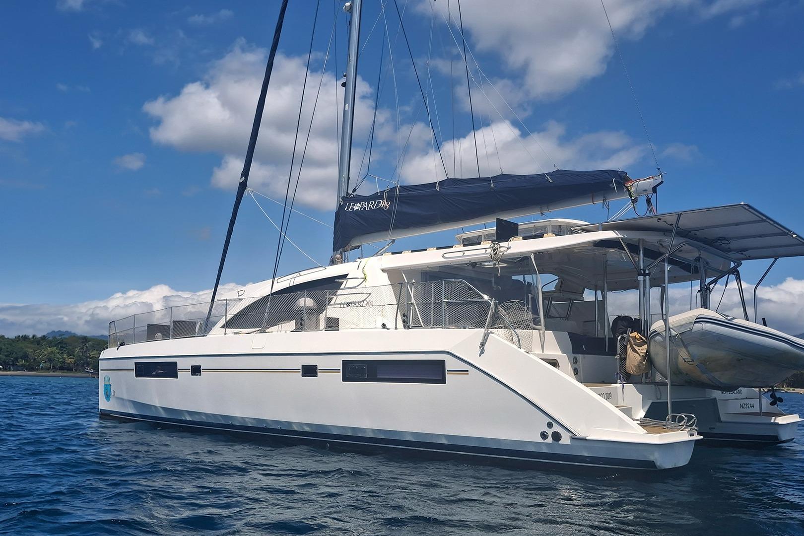 2013 Leopard 48 catamaran sailing on calm blue waters under a clear sky.