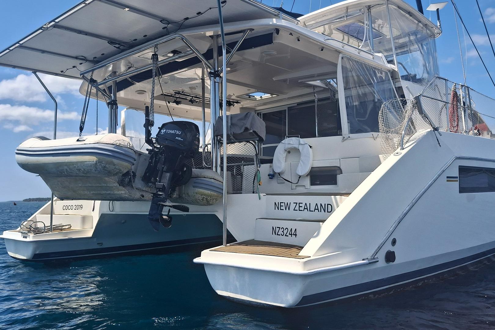 Catamaran Leopard 48, 2013 model, with dinghy and Tohatsu motor, anchored in New Zealand waters.