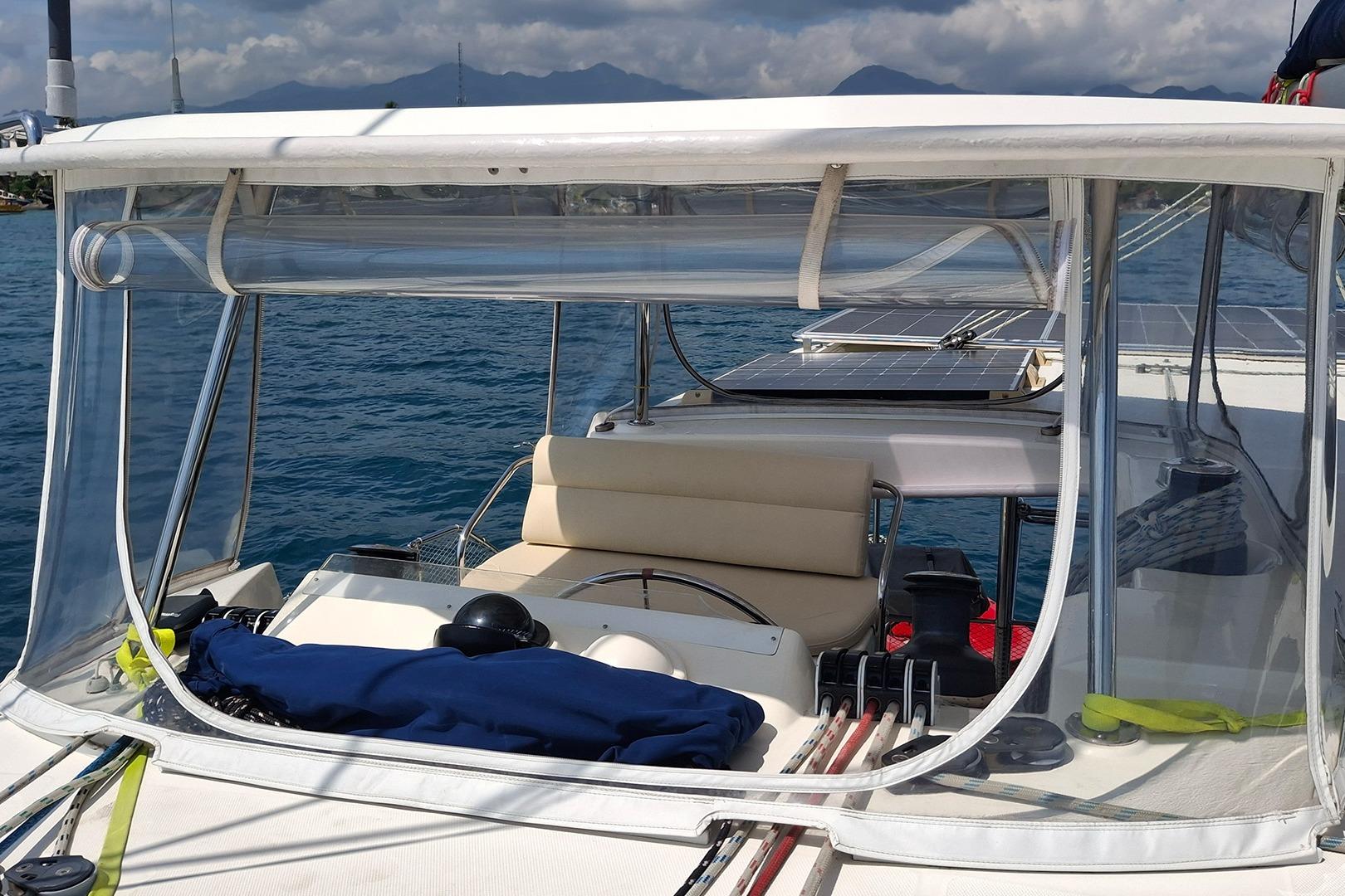 Leopard 48 yacht cockpit with clear enclosure, solar panels, and ocean view, 2013 model.