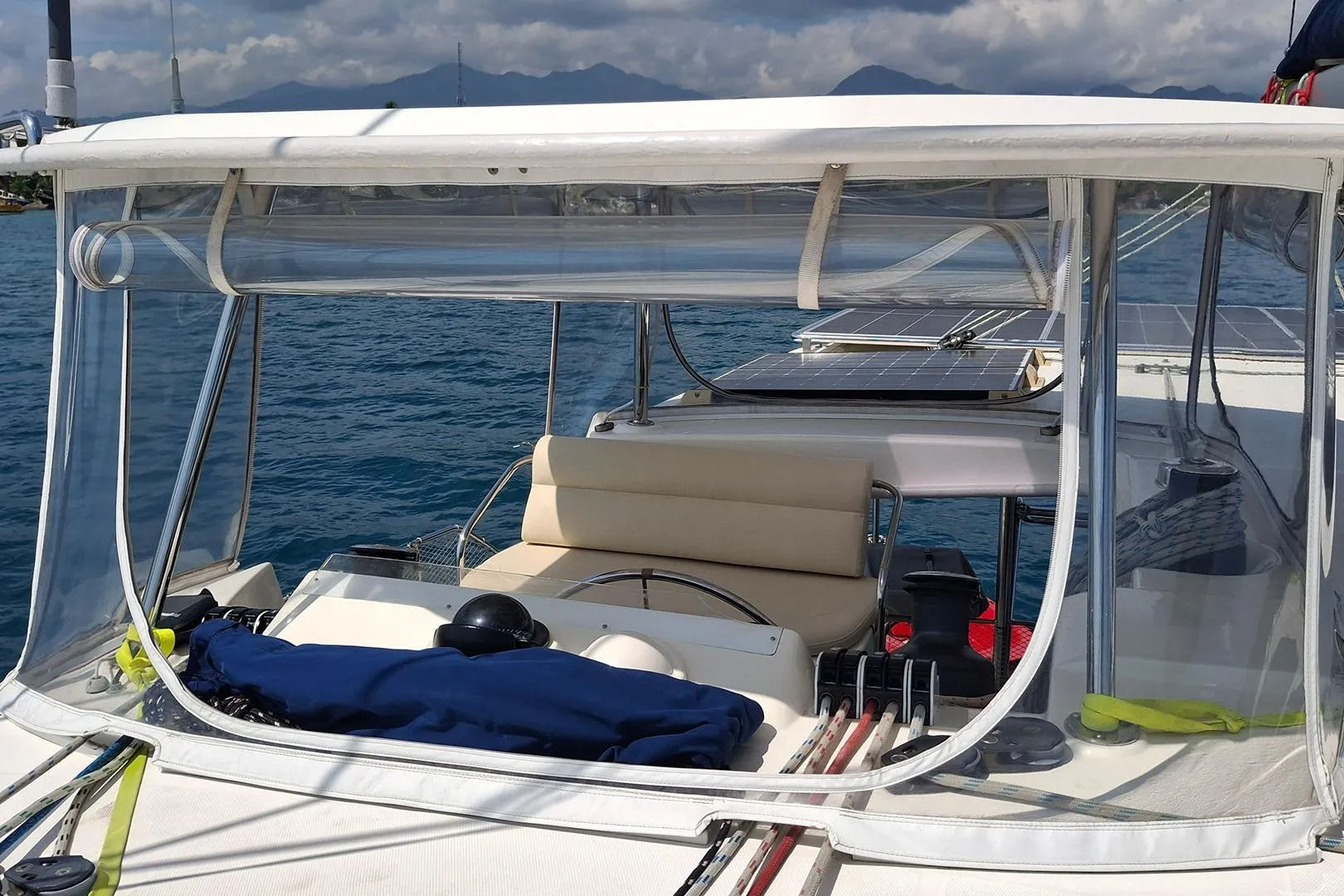 Leopard 48 yacht cockpit with clear enclosure, solar panels, and ocean view, 2013 model.