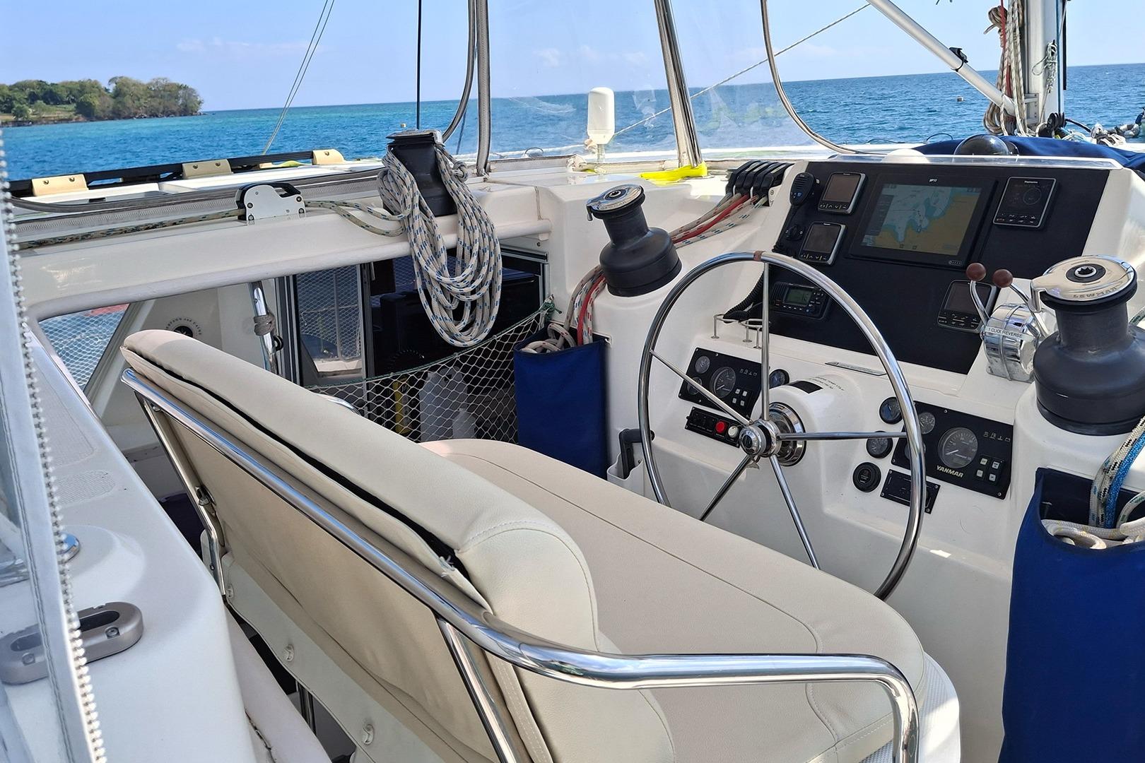 Cockpit of a 2013 Leopard 48 yacht with steering wheel and navigation equipment.