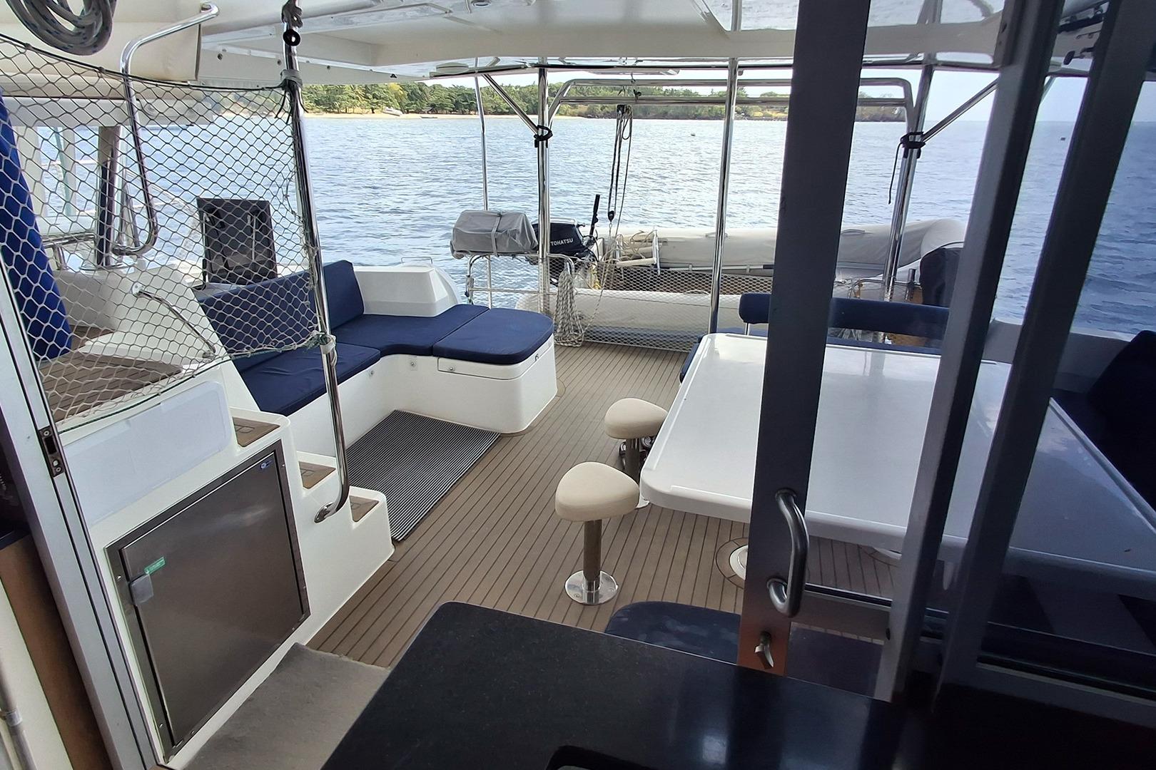 Interior of 2013 Leopard 48 yacht with seating, table, and ocean view.