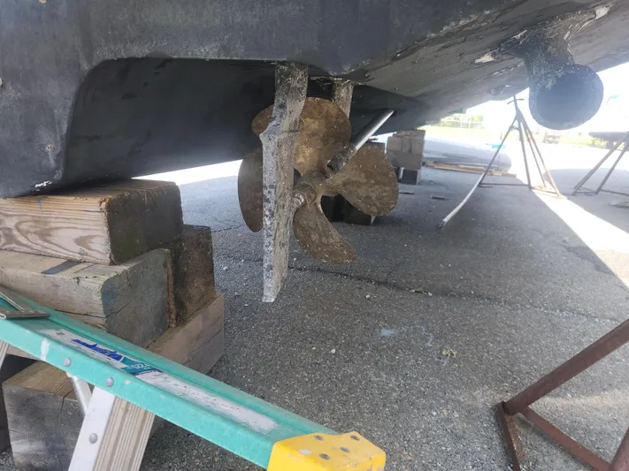  Yacht Photos Pics 2013 Sea Ray 370 Sundancer propeller and hull on dry dock, supported by wooden blocks.