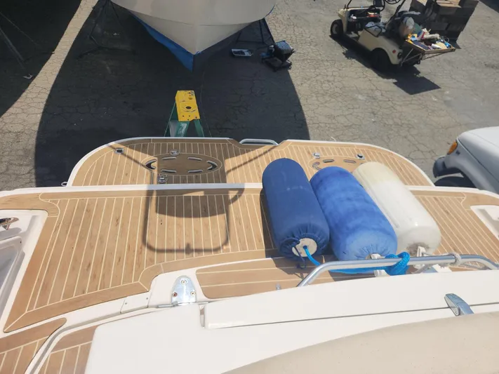  Yacht Photos Pics 2013 Sea Ray 370 Sundancer boat deck with blue and white fenders.