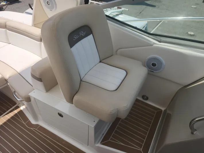  Yacht Photos Pics Captain's seat on 2013 Sea Ray 370 Sundancer boat, featuring beige and white upholstery.