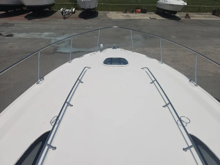  Yacht Photos Pics 2013 Sea Ray 370 Sundancer boat deck with railing, docked on a sunny day.