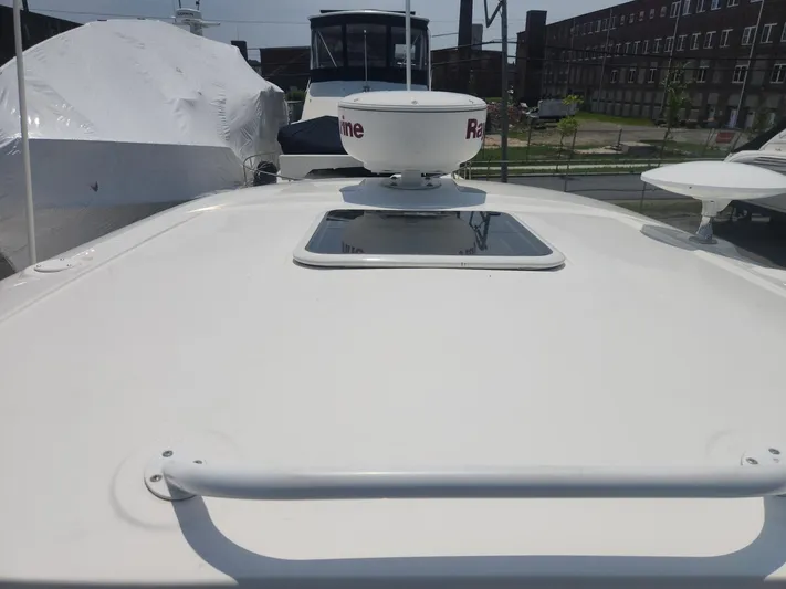  Yacht Photos Pics 2013 Sea Ray 370 Sundancer boat deck with radar and hatch, docked in marina.