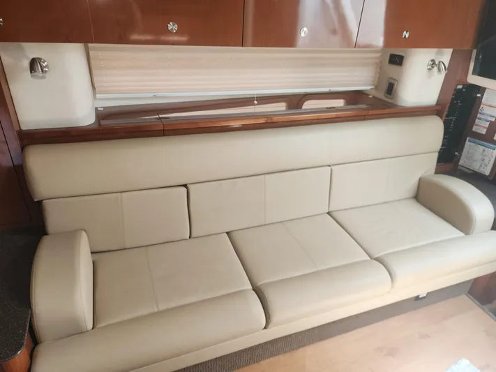  Yacht Photos Pics Interior of 2013 Sea Ray 370 Sundancer with beige leather seating and wooden cabinetry.
