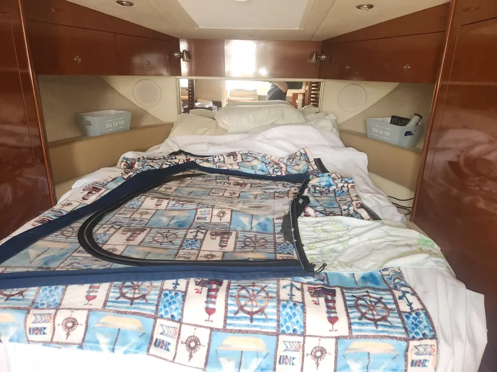  Yacht Photos Pics Cozy cabin interior of 2013 Sea Ray 370 Sundancer with nautical-themed bedding.