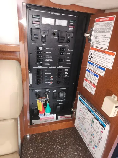 Yacht Photos Pics Electrical panel inside 2013 Sea Ray 370 Sundancer boat, featuring circuit breakers and safety labels.
