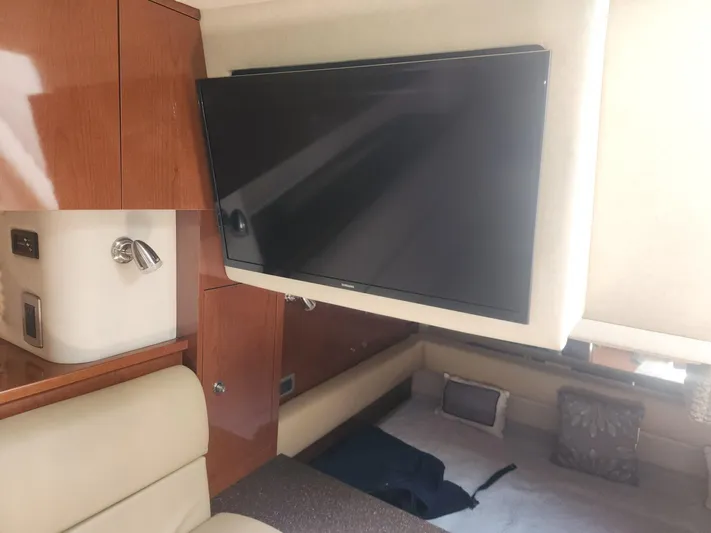  Yacht Photos Pics Interior of 2013 Sea Ray 370 Sundancer with mounted TV and wooden cabinetry.