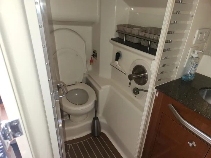  Yacht Photos Pics Bathroom interior of 2013 Sea Ray 370 Sundancer yacht, featuring toilet and storage shelves.