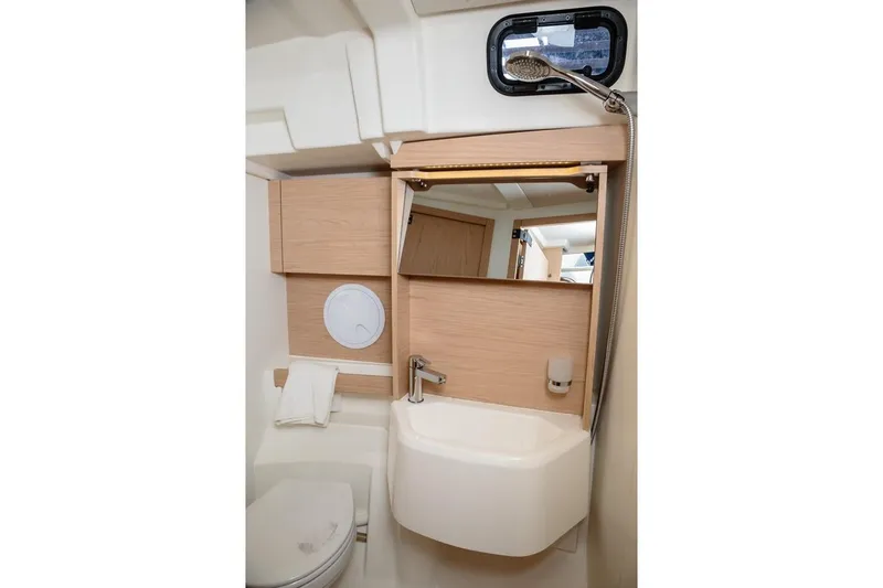  Yacht Photos Pics Bathroom interior of 2018 Beneteau Oceanis 51.1 yacht with modern fixtures and wooden accents.