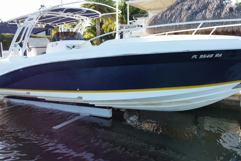  Yacht Photos Pics 2004 Deep Impact 36 DI boat docked, featuring sleek design and blue hull.