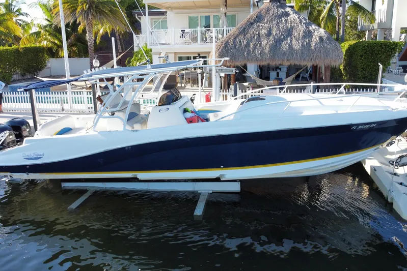  Yacht Photos Pics 2004 Deep Impact 36 DI boat docked near tropical waterfront home.