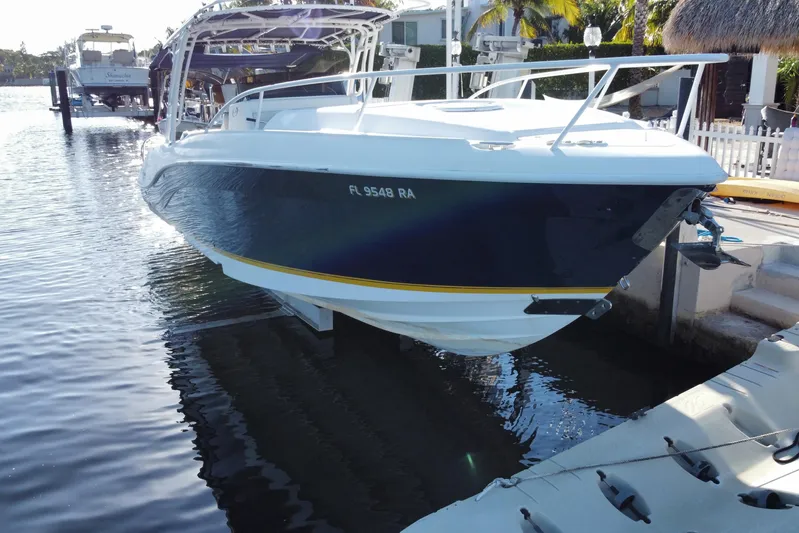  Yacht Photos Pics 2004 Deep Impact 36 DI boat docked in a marina, side view.