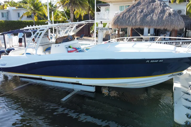  Yacht Photos Pics 2004 Deep Impact 36 DI boat docked near tropical waterfront home.