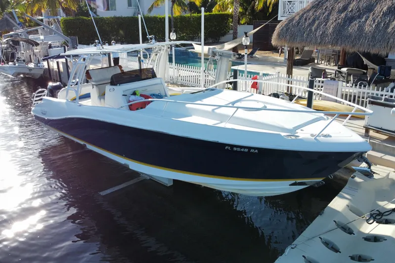  Yacht Photos Pics 2004 Deep Impact 36 DI boat docked by a waterfront property.