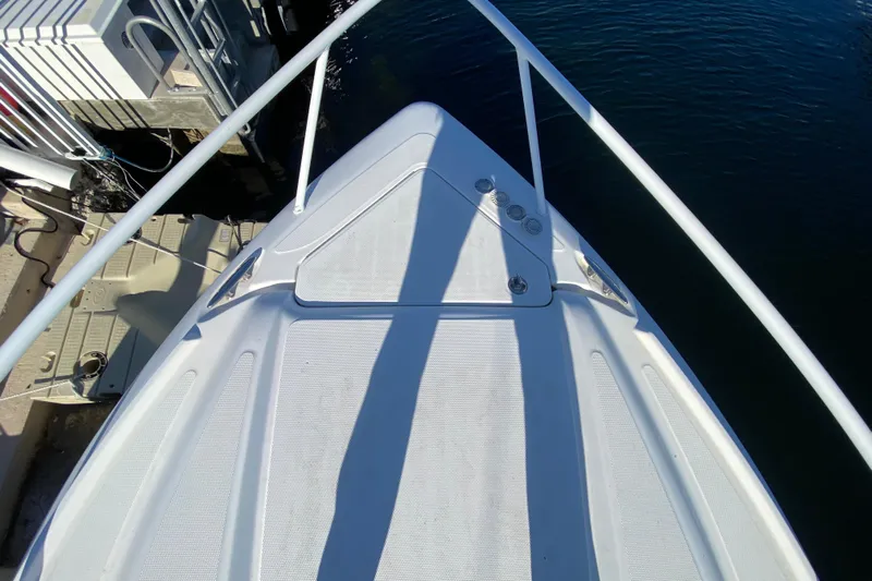  Yacht Photos Pics Bow of 2004 Deep Impact 36 DI boat docked by water.