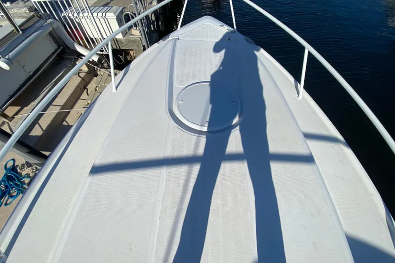 Yacht Photos Pics Bow of 2004 Deep Impact 36 DI boat with shadow and dock view.