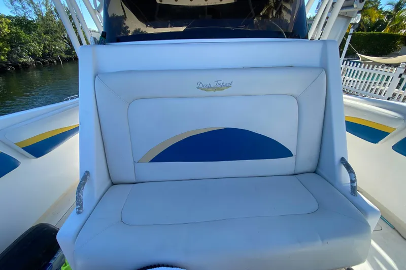  Yacht Photos Pics 2004 Deep Impact 36 DI boat seat with logo, featuring blue and yellow accents.