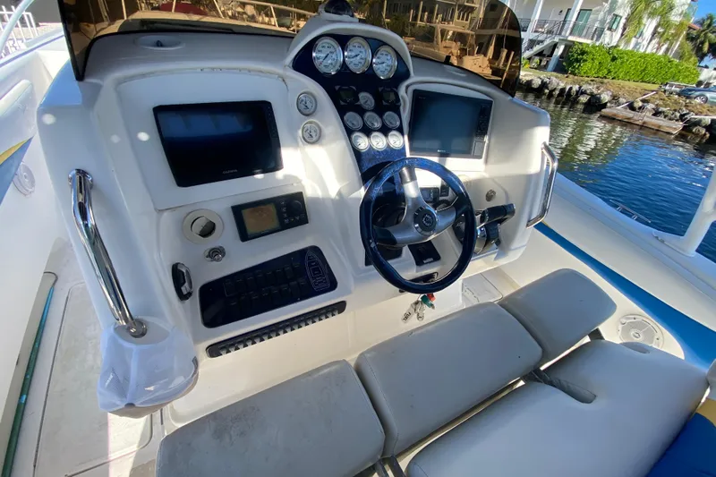  Yacht Photos Pics Control panel of a 2004 Deep Impact 36 DI boat with steering wheel and gauges.