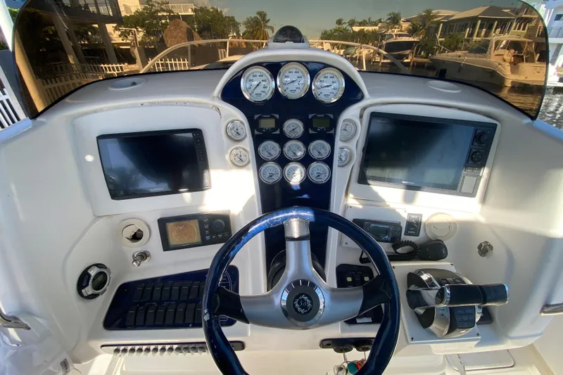  Yacht Photos Pics 2004 Deep Impact 36 DI boat dashboard with gauges, steering wheel, and navigation screens.