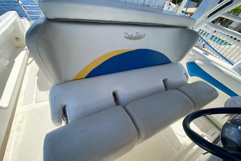  Yacht Photos Pics 2004 Deep Impact 36 DI boat seating with logo and blue-yellow design.