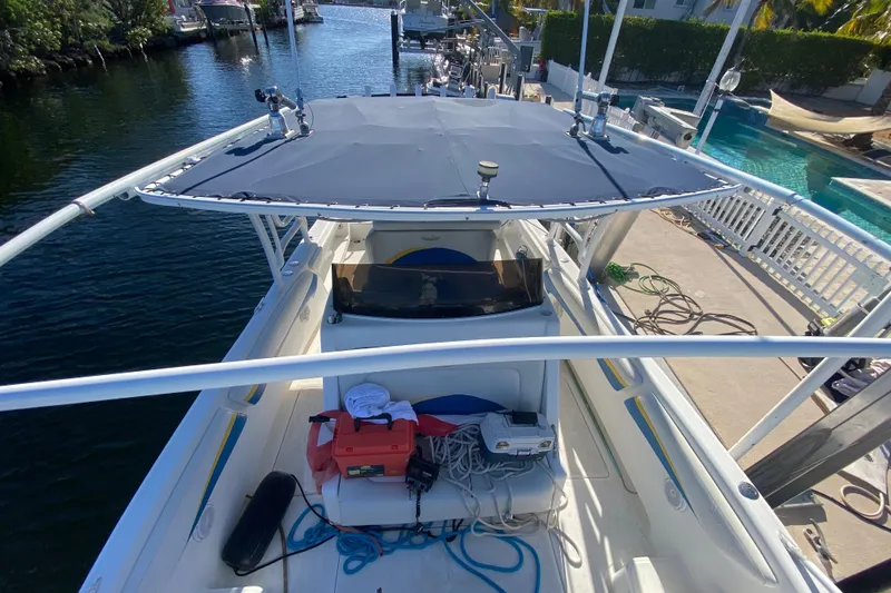  Yacht Photos Pics 2004 Deep Impact 36 DI boat docked, featuring a spacious deck and canopy.