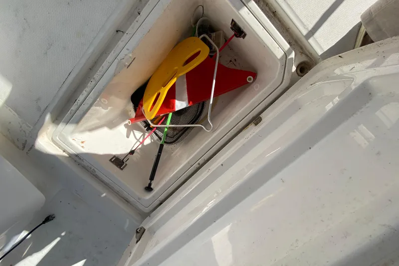  Yacht Photos Pics Storage compartment on 2004 Deep Impact 36 DI boat with safety equipment.