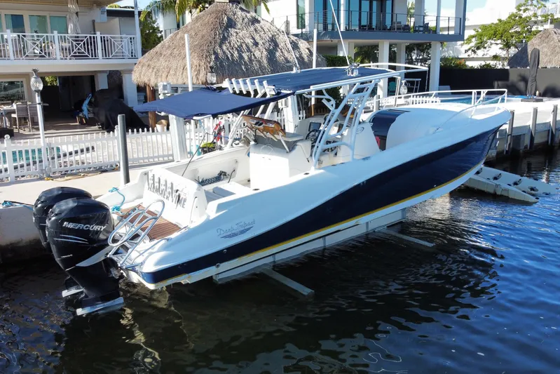  Yacht Photos Pics 2004 Deep Impact 36 DI boat docked with dual Mercury engines, near waterfront homes.
