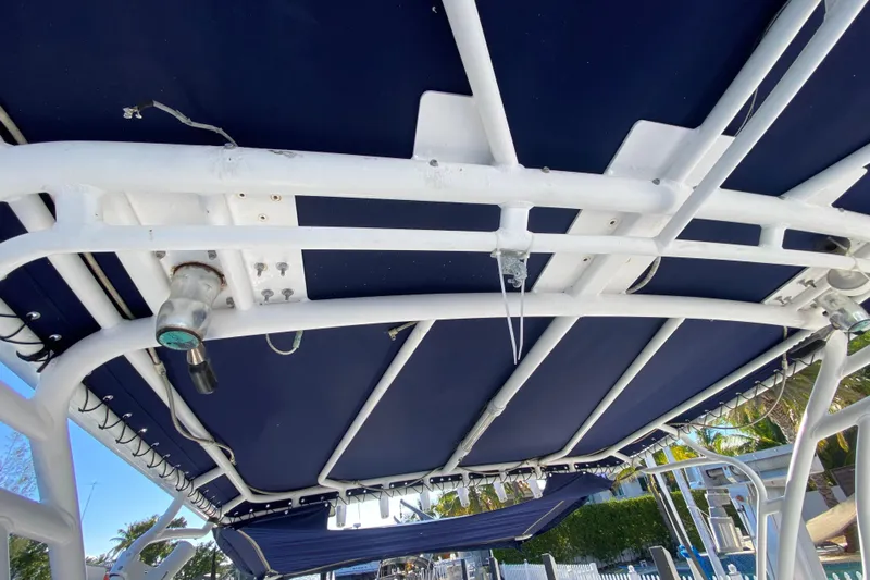  Yacht Photos Pics 2004 Deep Impact 36 DI boat canopy with white frame and blue cover.