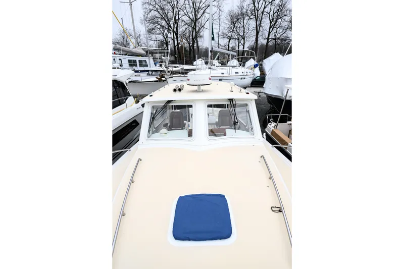 Staying Stoked Yacht Photos Pics 2005 MJM 34z Downeast boat docked, showcasing its sleek design and spacious deck.