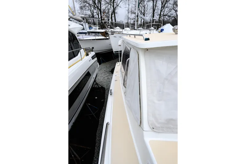 Staying Stoked Yacht Photos Pics 2005 MJM 34z Downeast boat docked among other vessels in a marina.