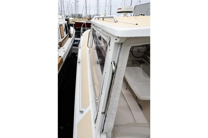 Staying Stoked Yacht Photos Pics 2005 MJM 34z Downeast boat docked, showcasing sleek design and spacious interior.