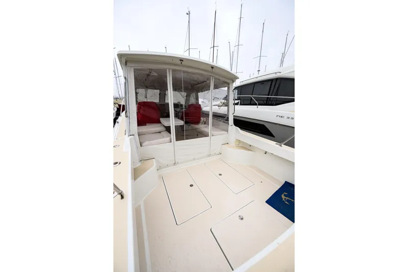 Staying Stoked Yacht Photos Pics 2005 MJM 34z Downeast boat with enclosed cockpit and visible seating area.