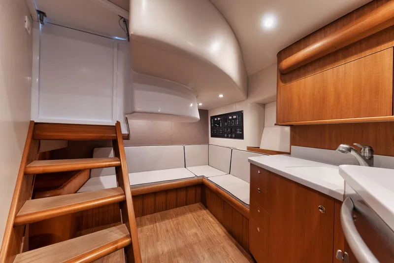 Dog House Yacht Photos Pics Luxurious 2016 F&S Express yacht interior with wooden cabinetry and seating area.