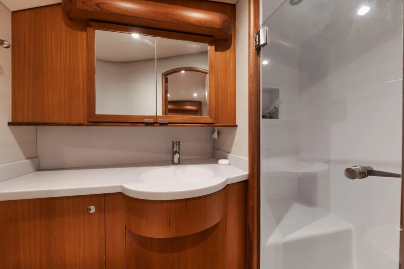 Dog House Yacht Photos Pics Luxurious 2016 F&S Express yacht bathroom with wooden cabinetry and modern fixtures.